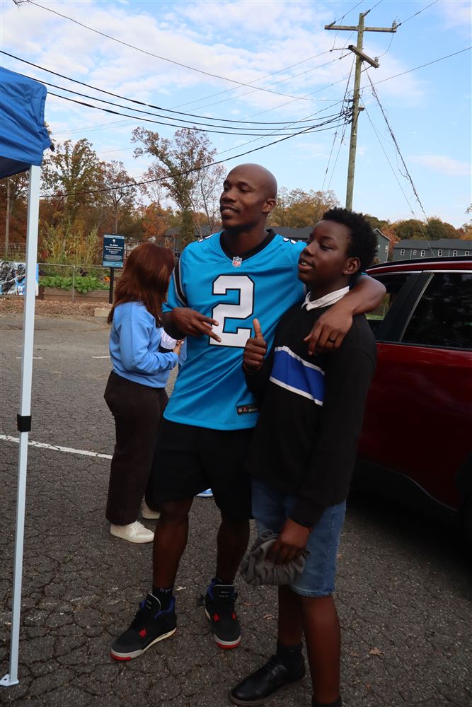 Mike Jackson posing with a young volunteer at the food drive